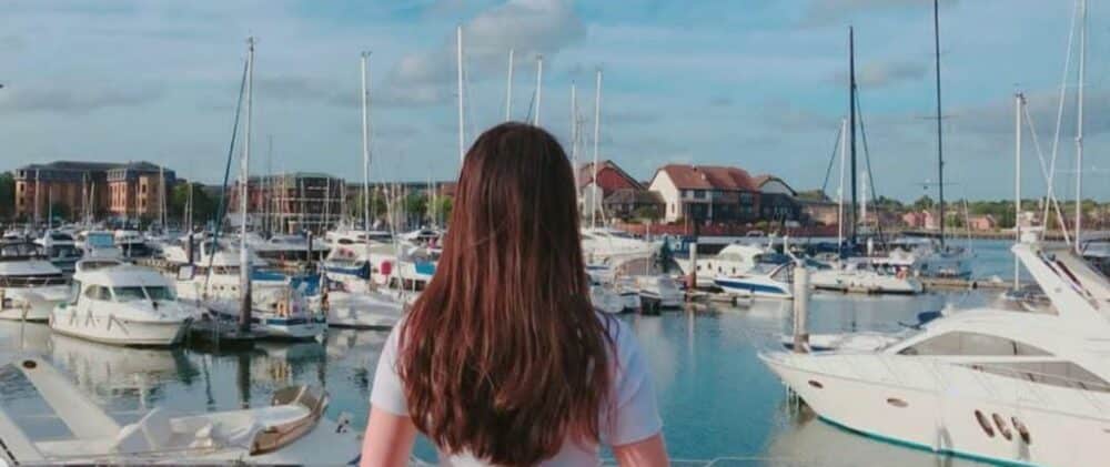 Ocean Village Marina in Southampton, with a woman in the foreground watching the boats