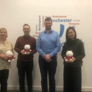 A photo of UKEC staff meeting university of Sheffield staff and exchanging gifts